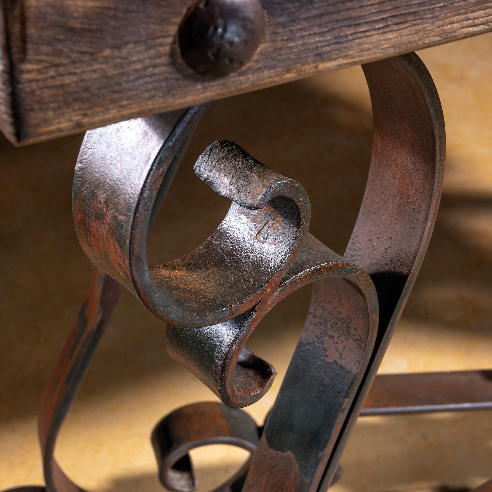 Ornate forged iron scrollwork with rustic patina finish – Into The West