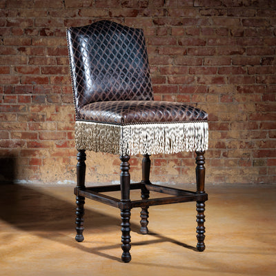Custom Western bar stool with printed suede back, diamond leather seat, and dark wood legs