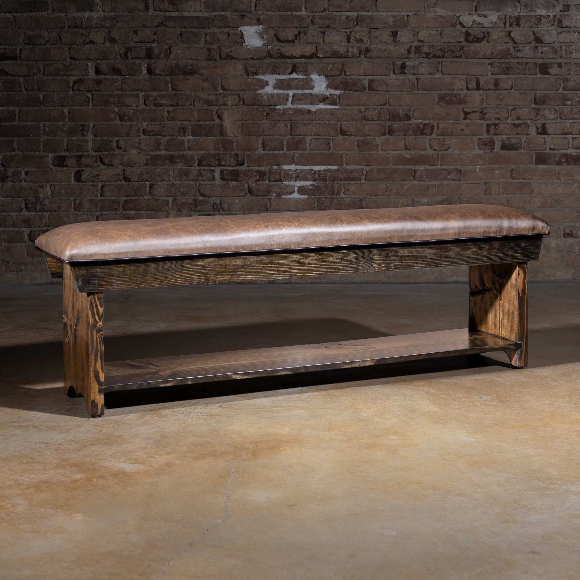 Tularosa Saddle Bench western bench with brown top-grain leather seat, dark wood base, and lower storage shelf