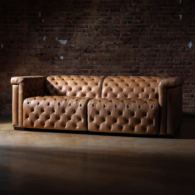 Front view of custom Western leather recliner sectional with top-grain leather and tufted cushions