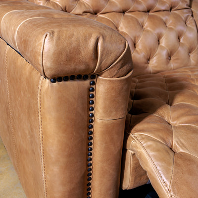 Detail of top-grain leather texture and craftsmanship on Urban Cowboy sectional sofa