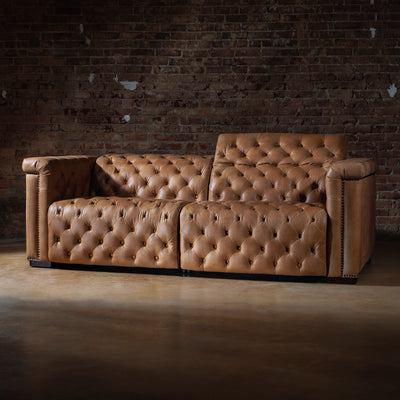 Reclined position of custom leather sectional showing motion features and plush cushioning