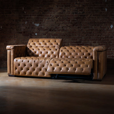 Reclined position of custom leather sectional showing motion features and plush cushioning