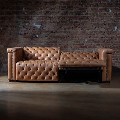 Reclined position of custom leather sectional showing motion features and plush cushioning
