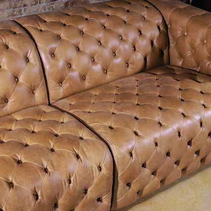 Close-up of hand-tufted seat back and armrest detailing on Western leather sectional