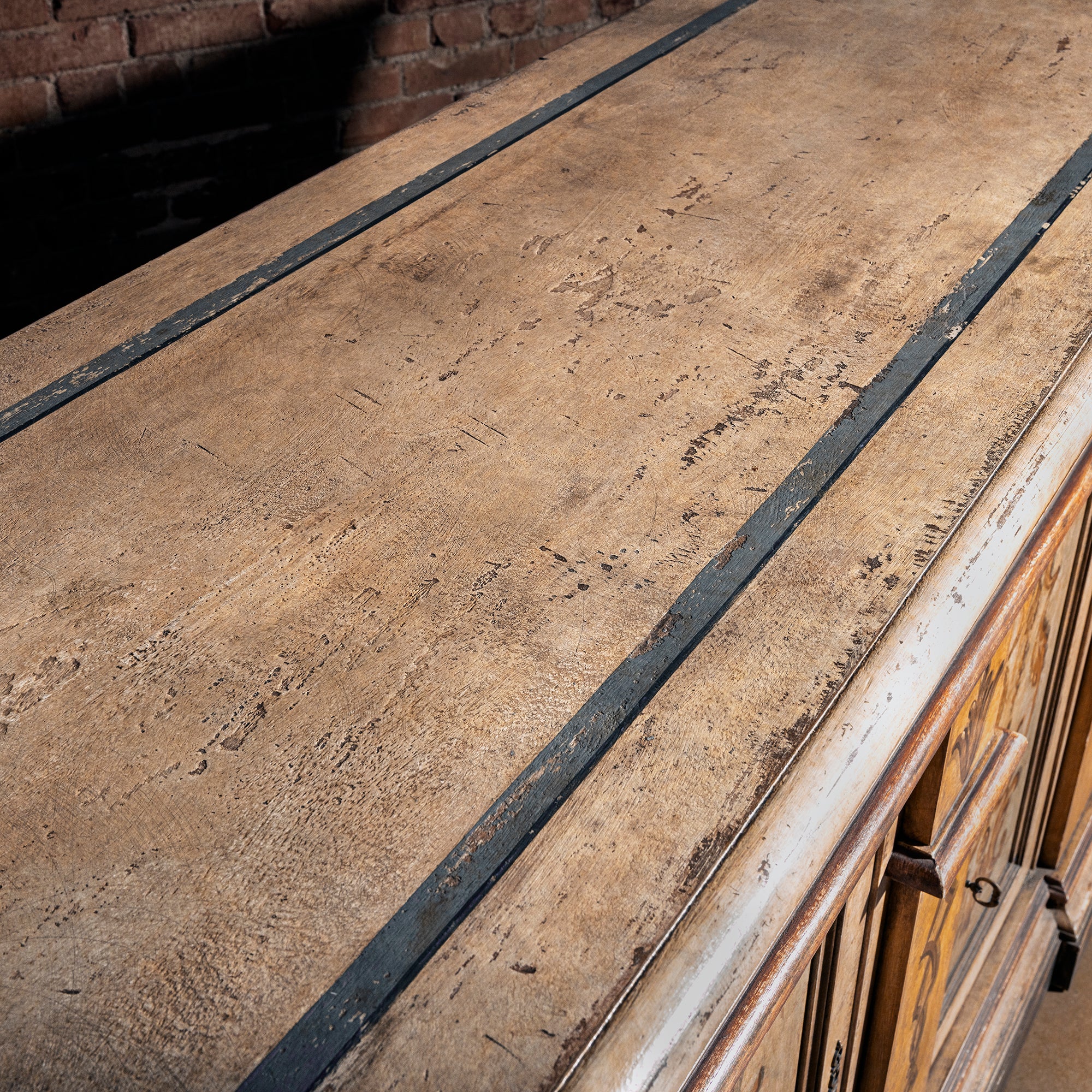 Valencia Crest Heirloom Buffet western buffet sideboard top detail with weathered planked surface and dark trim in aged finish.
