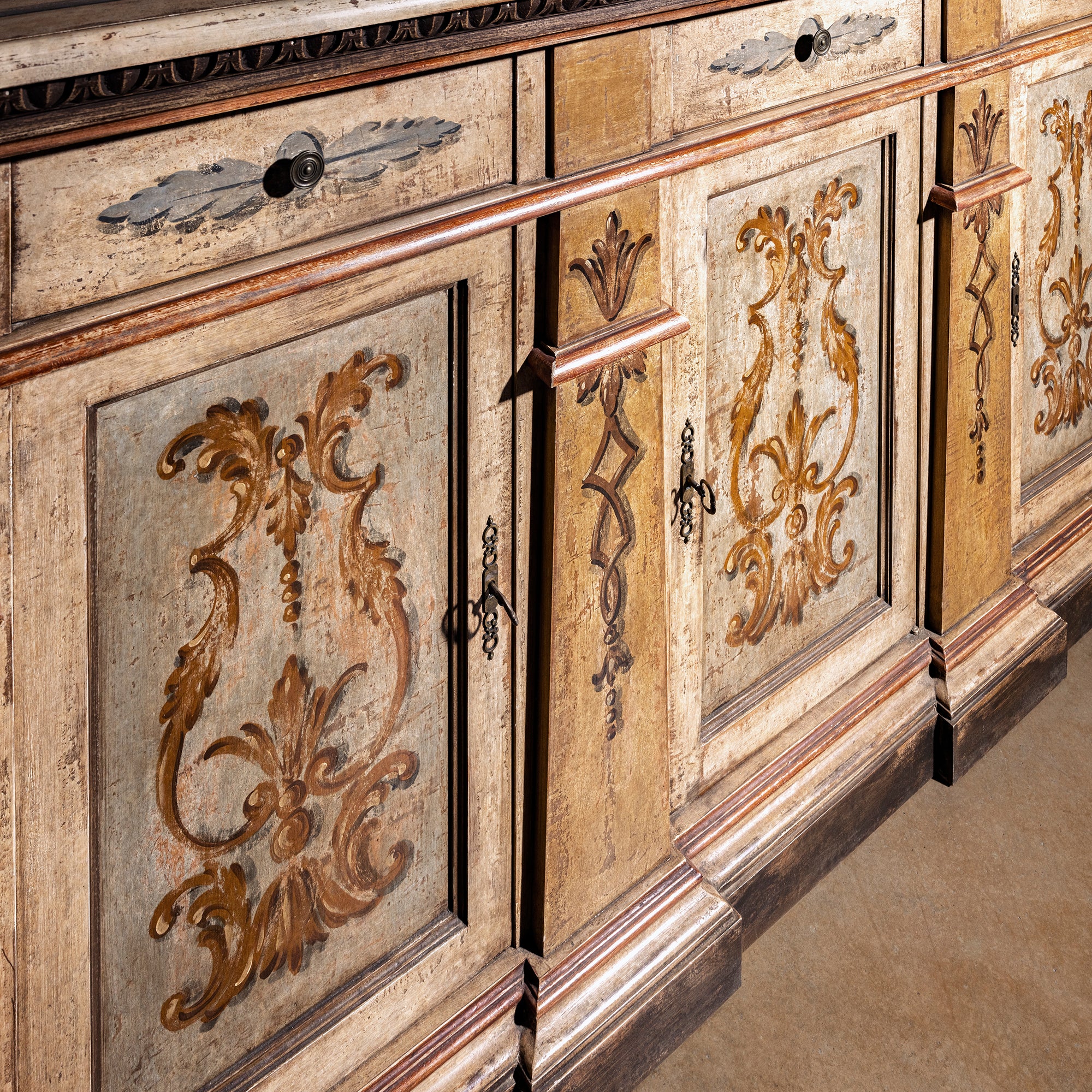 Valencia Crest Heirloom Buffet western buffet sideboard front angle showing hand-painted doors, carved accents, and plinth base.