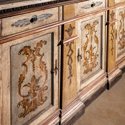 Valencia Crest Heirloom Buffet western buffet sideboard front angle showing hand-painted doors, carved accents, and plinth base.