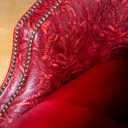 Arm detail showing red tooled leather and nailhead trim on Vaquera Royale Western swivel chair