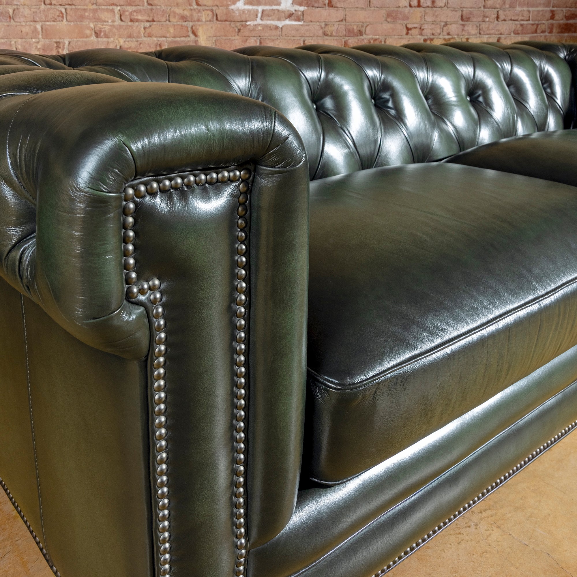 Verde Sovereign western sofa in deep green top-grain leather with Chesterfield tufting, rolled arms, and antique nailhead trim