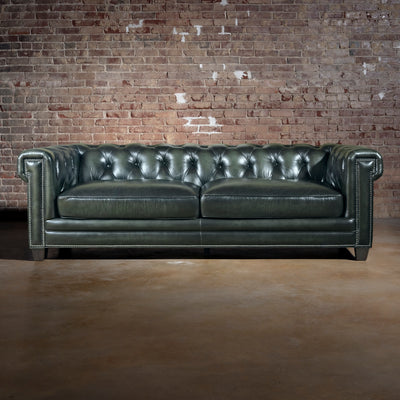 Verde Sovereign western sofa front view with button-tufted back, rolled arms, two leather cushions, and nailhead detailing