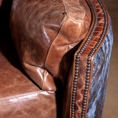 Close-up of antique nailhead trim and brindle hide on Space Cowboy recliner