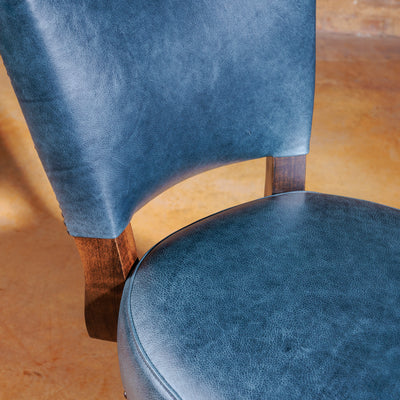 Top-down view of contoured leather seat and rich wood finish