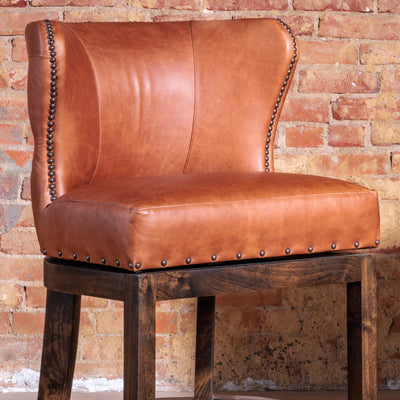 Close-up of memory swivel base and solid wood frame on Western bar stool