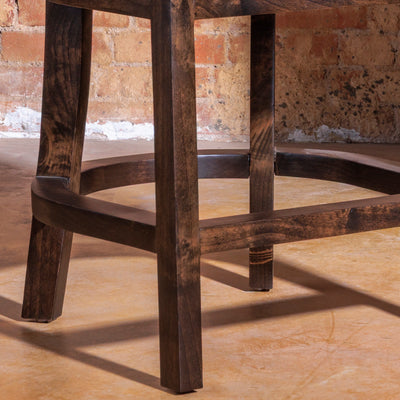 Curved-back Western leather bar stool with nailhead trim and walnut legs