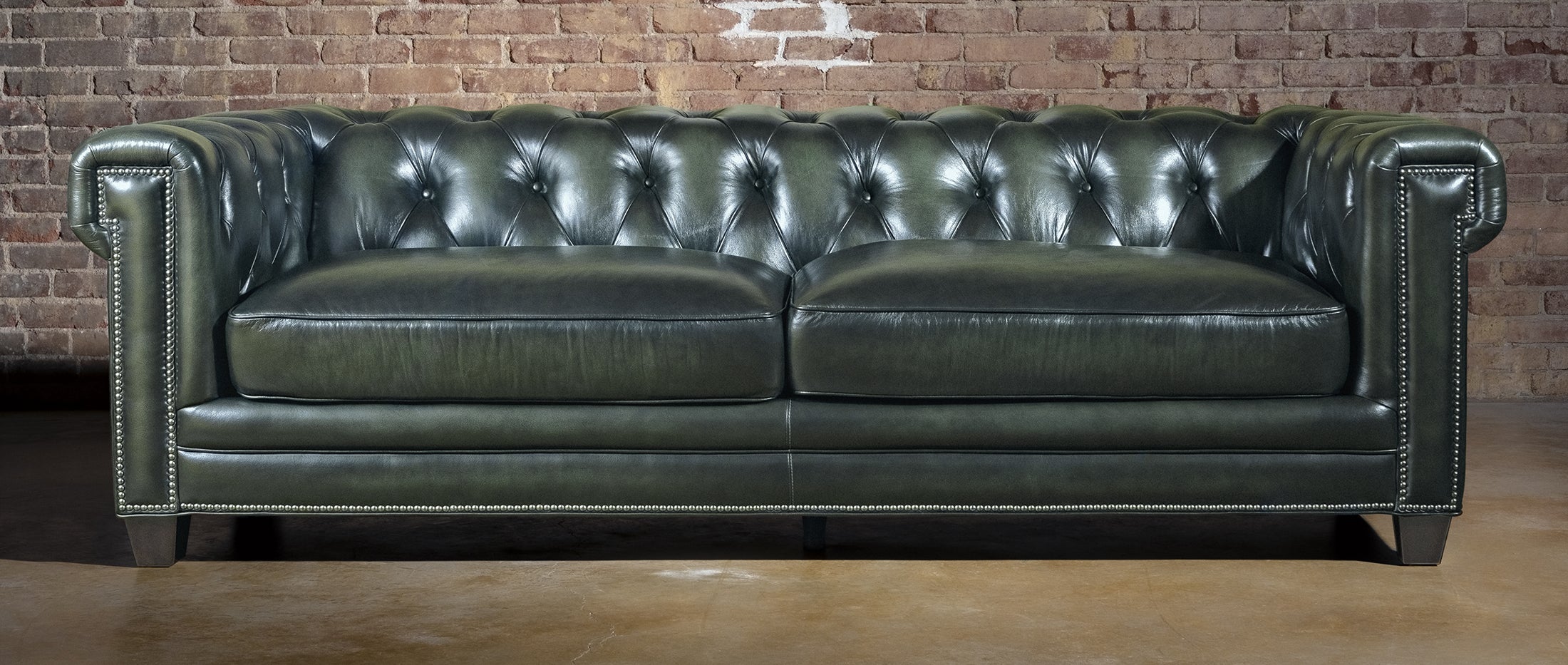Verde Sovereign western sofa in deep green top-grain leather with Chesterfield tufting, rolled arms, and antique nailhead trim