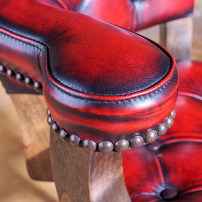 Hand-rubbed red leather and tufting on luxury bar stool nailhead trim