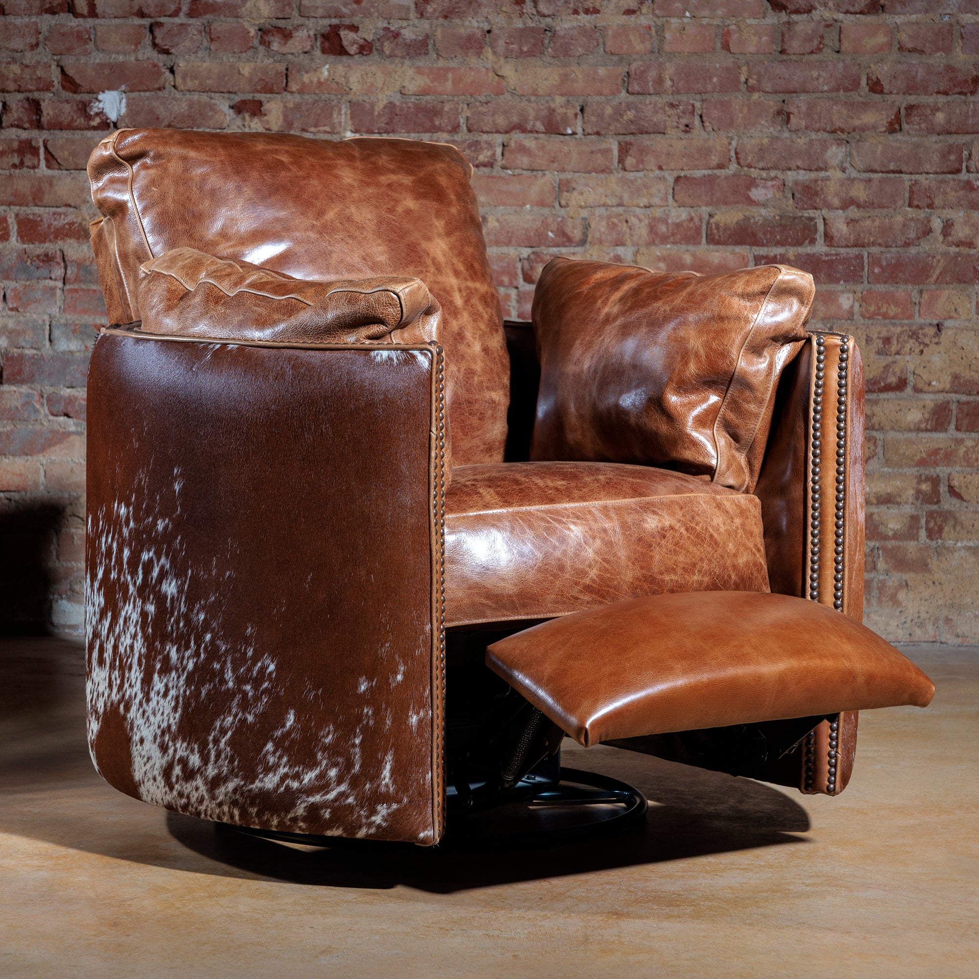 Big Texan leather recliner in push-back recline position with 360-degree swivel base and cowhide accents