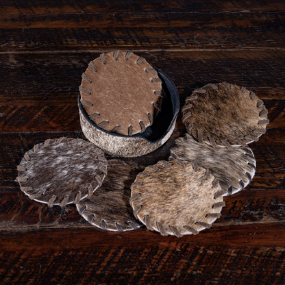 Genuine cowhide coasters from Into The West — handcrafted Western drinkware accessory and hostess gift.