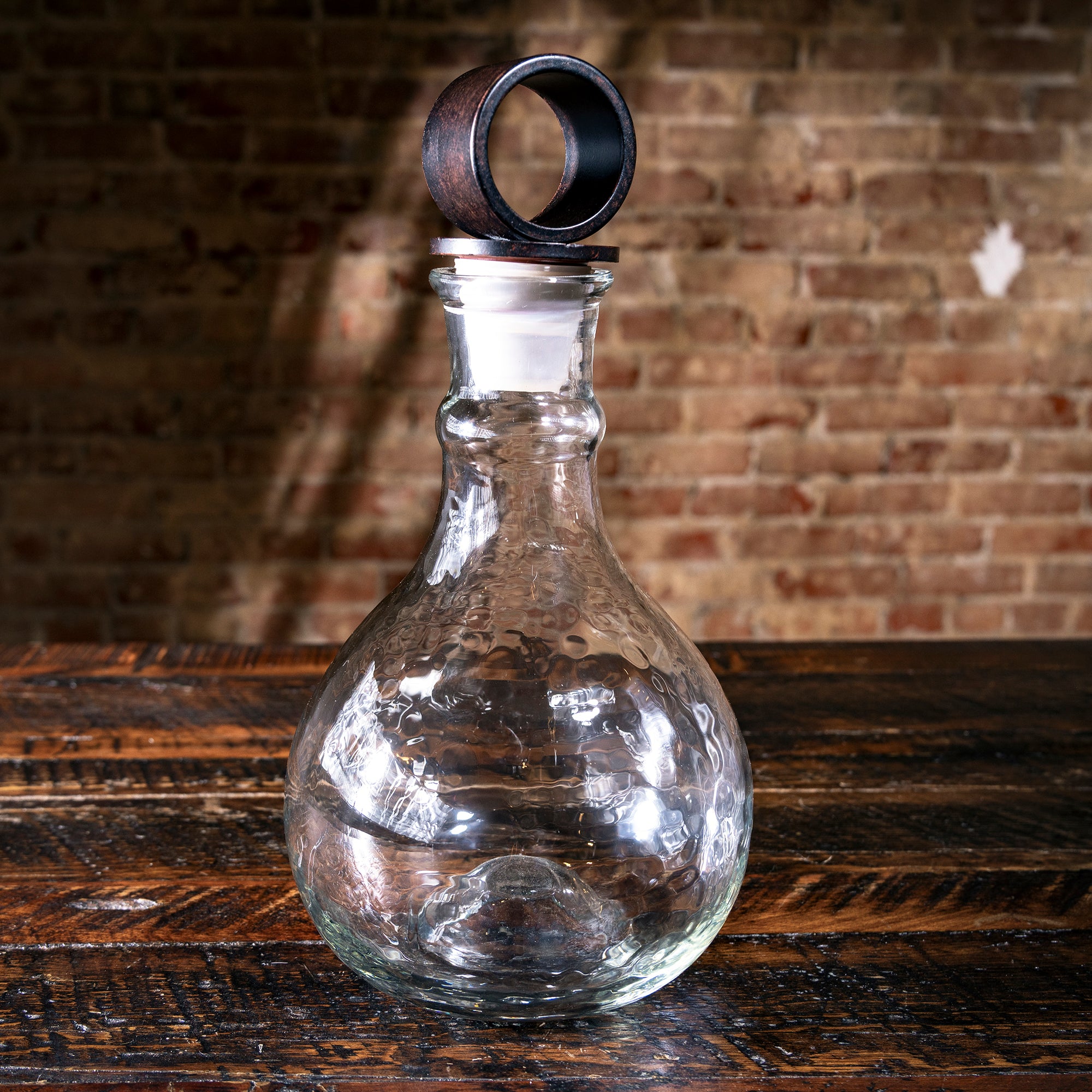 Western-style whiskey decanter for ranch homes — glass and iron accent for cowboy bar décor.