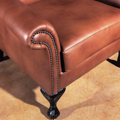Rolled arm with bronze nailhead trim on Western leather wingback chair