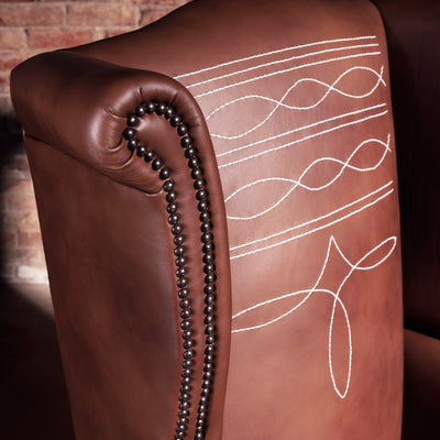Close-up of decorative Western-style stitch pattern on leather wingback chair