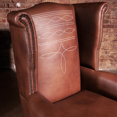 Side view of Western wingback chair with rolled arms and top-grain leather