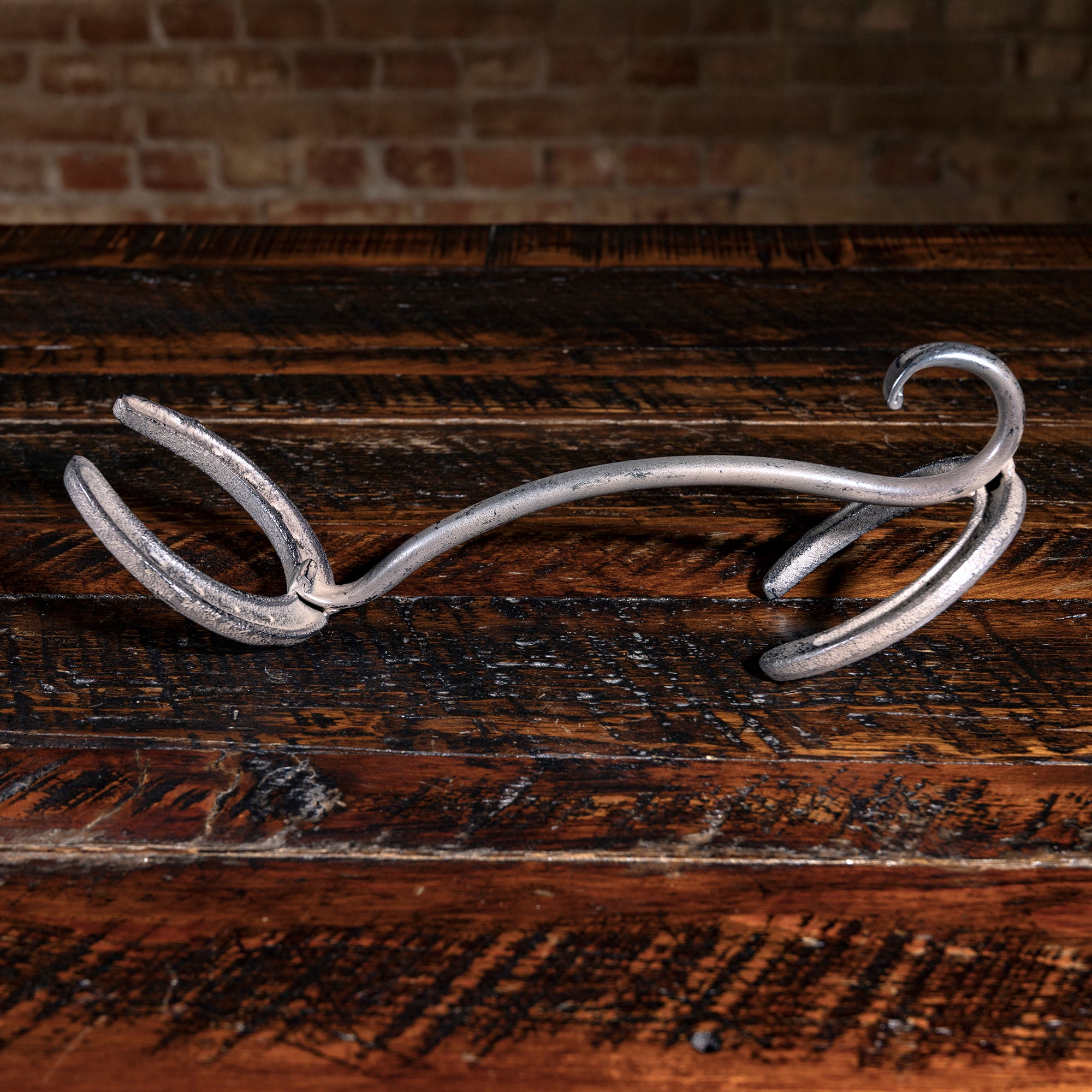 Hand-forged iron horseshoe hat rack from Into The West — rustic Western cowboy home décor piece.