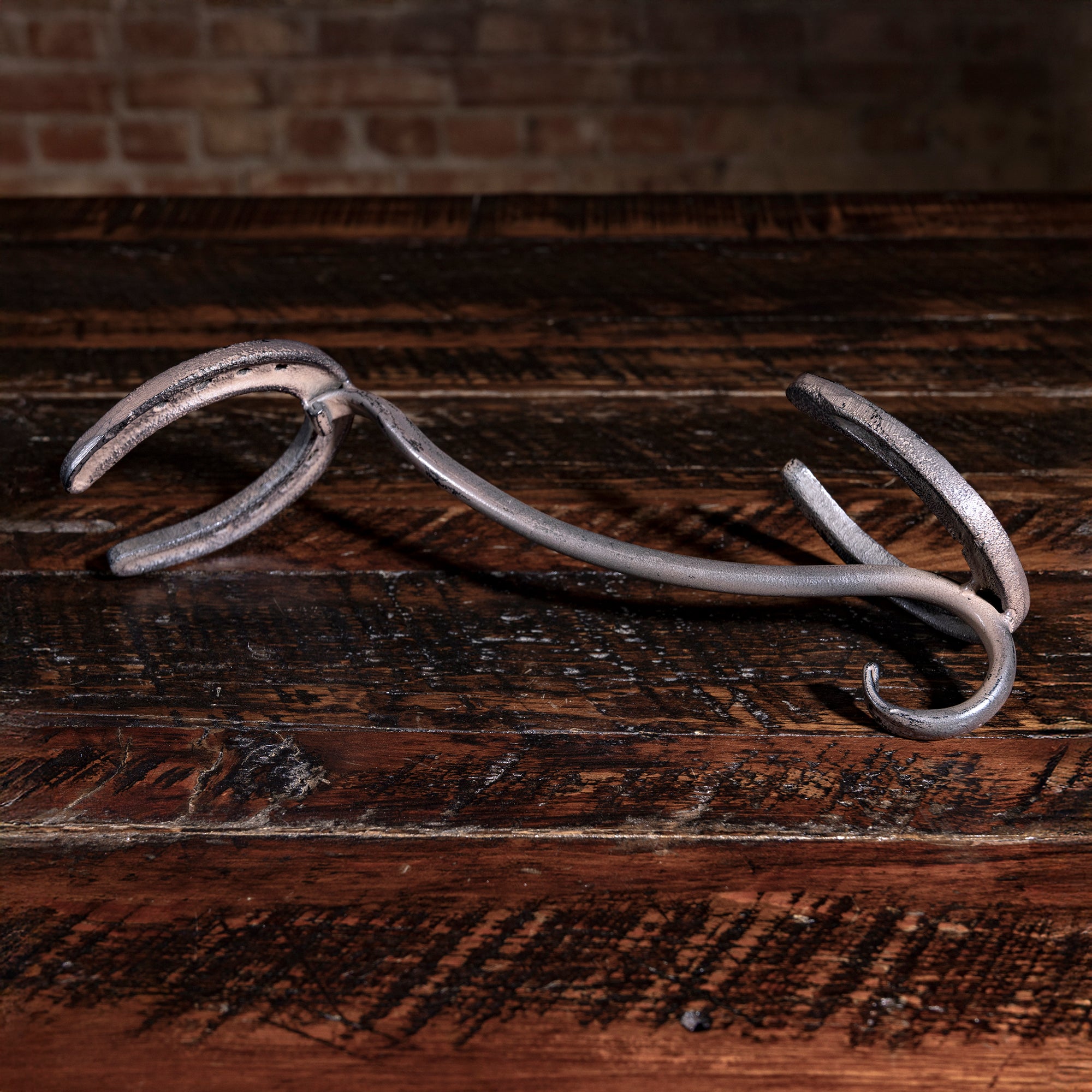 Western-style iron horseshoe hat rest — handcrafted cowboy hat holder for ranch or cabin entryway.