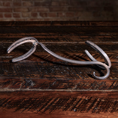 Western-style iron horseshoe hat rest — handcrafted cowboy hat holder for ranch or cabin entryway.