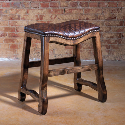 Western saddle-style stool with brown quilted leather seat and solid wood frame.