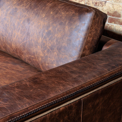 Custom Western sectional sofa in brown leather with wide chaise and timeless rustic appeal