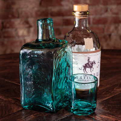eal decanter set displayed next to Western-style tequila bottle